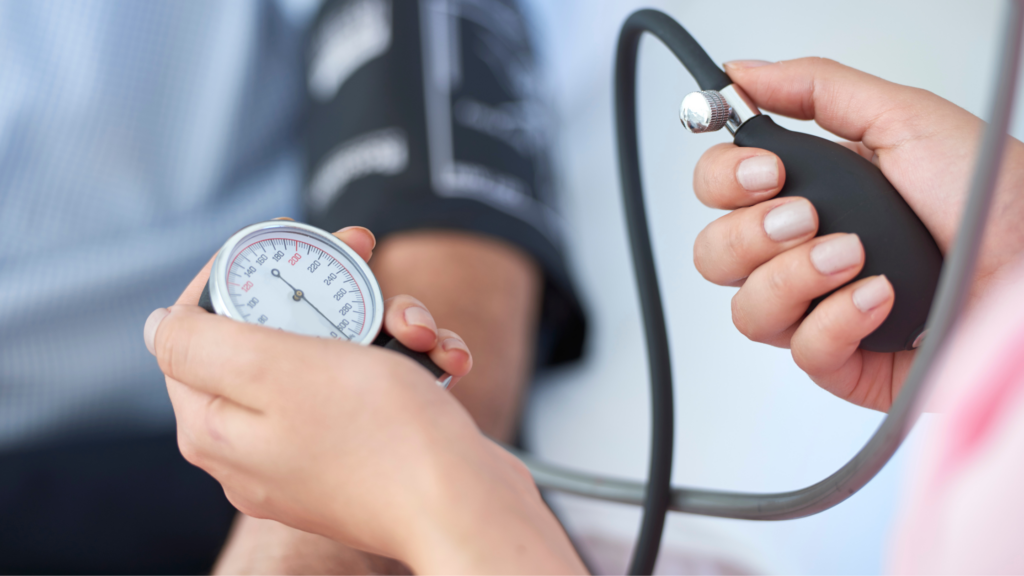 In this image, a patient's blood pressure is being measured as part of a panel of tests for preventative health screenings. 