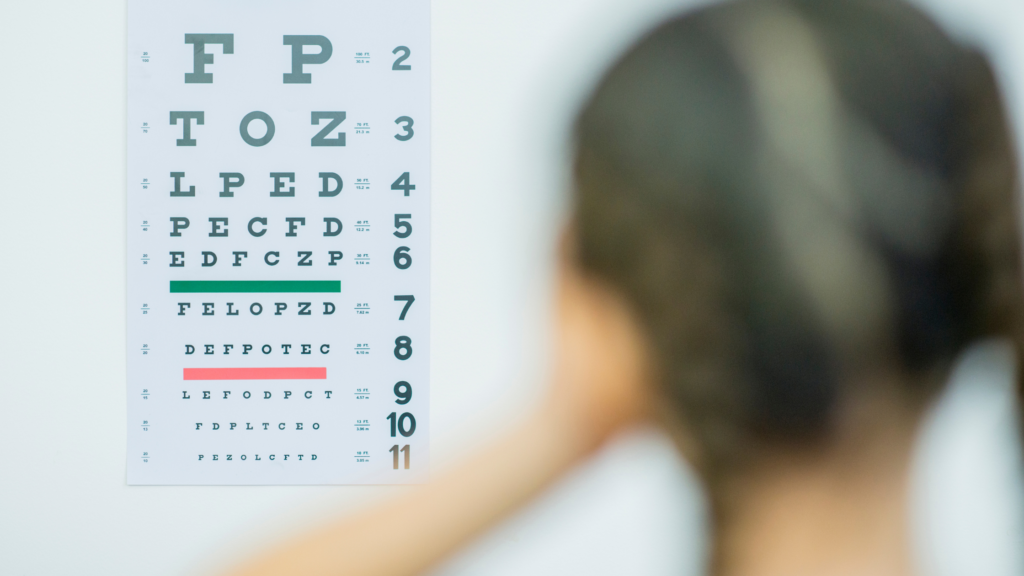 In this image, a patient's eye sight is being tested as part of a panel of tests for preventative health screenings. 